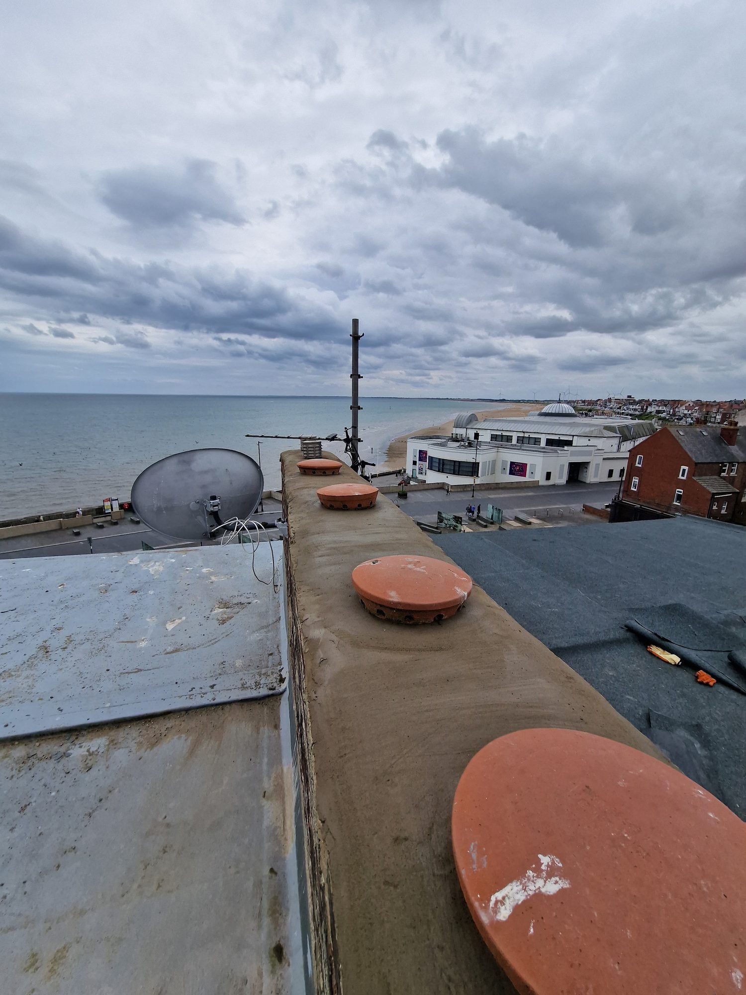 Chimney stack with capped pots, the sea beyond