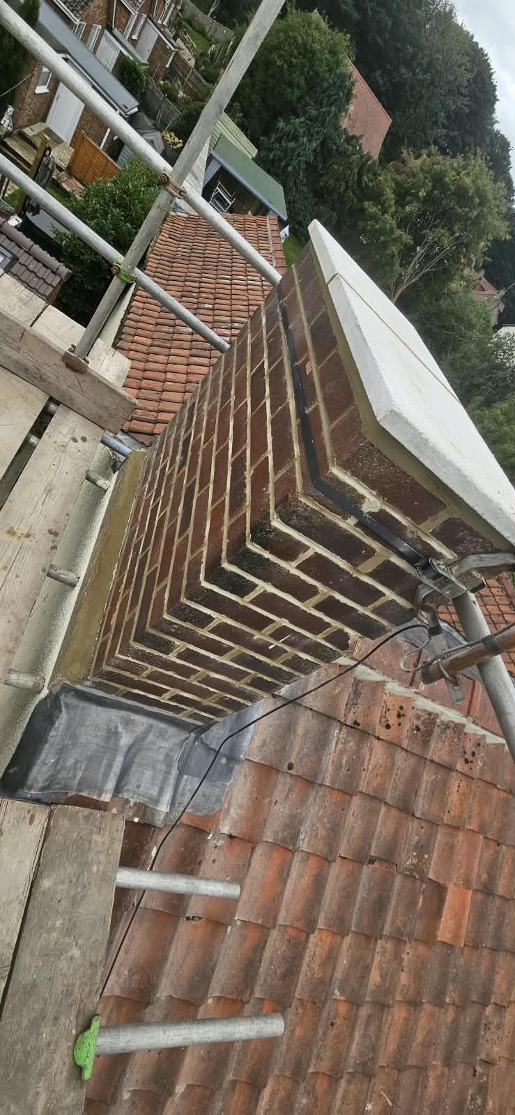 Brick chimney stack with new lead flashing, seen from the scaffold