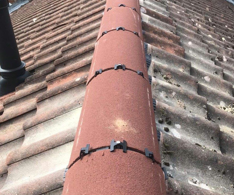 Red ridge tiles fixed with mechanical ridge clips