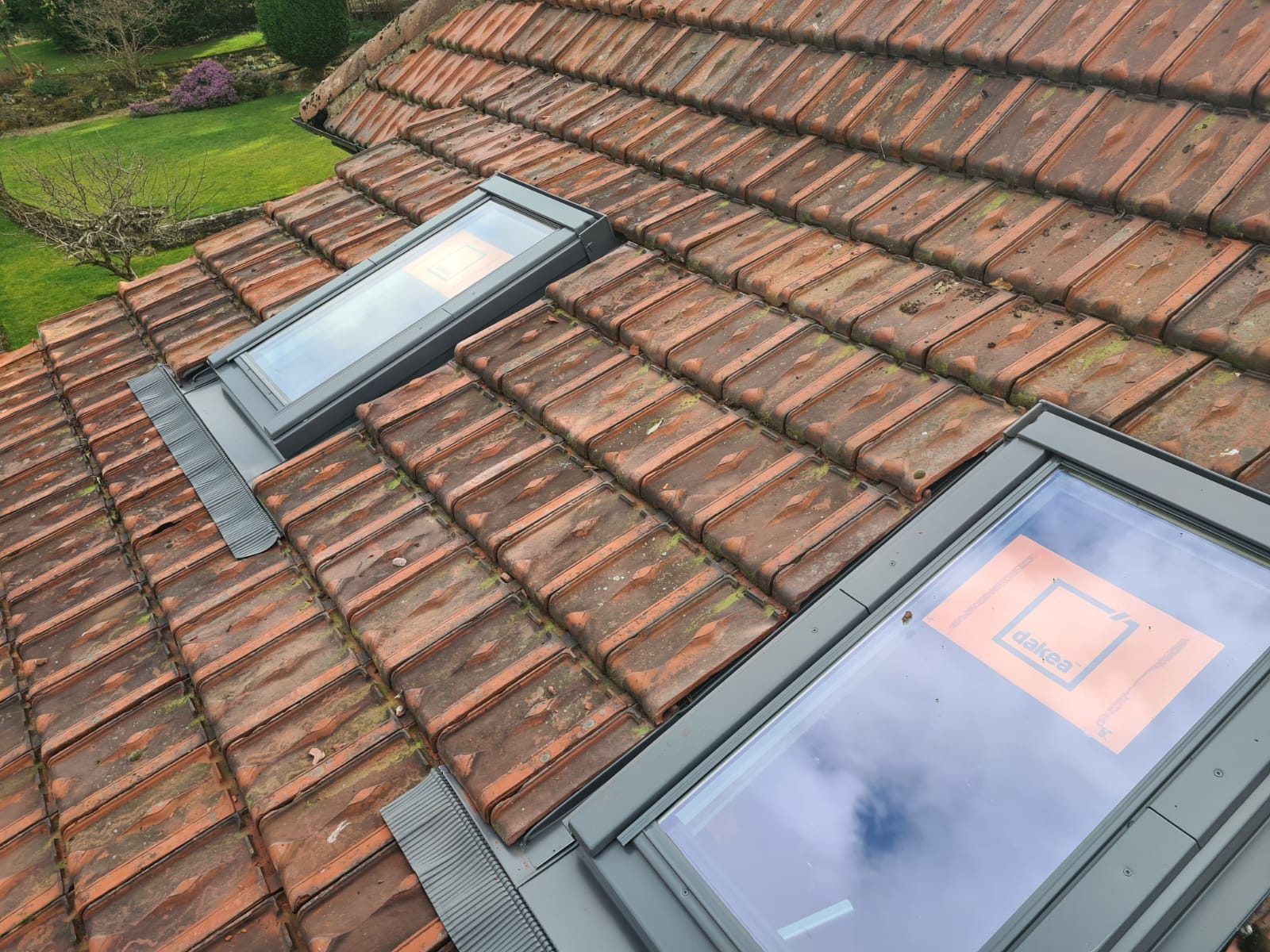Two roof windows set into a red tiled roof